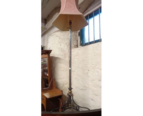 A standard lamp formed from a converted telescopic oil lamp standard with coppered detailing and scroll tripod base, with sha