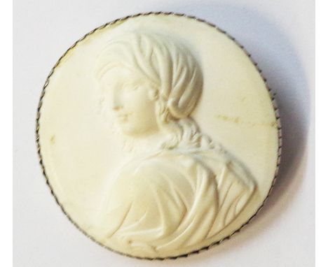 A 5.5cm diameter white metal framed white lava cameo brooch, depicting a head and shoulders portrait of a classical maiden