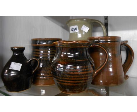 A quantity of Leach pottery St. Ives standard and other wares comprising celadon glazed jug, two tankards with tenmoku glazes
