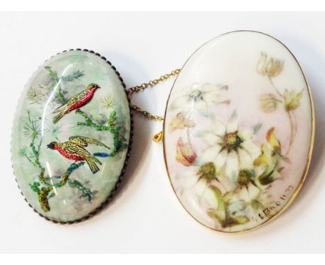 A 6.7cm marked 9ct framed oval ceramic panel brooch with signed hand painted floral decoration - sold with a gilt metal frame