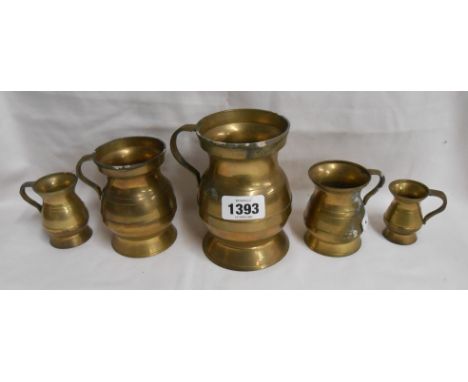 A set of five vintage graduated brass measures of tankard form