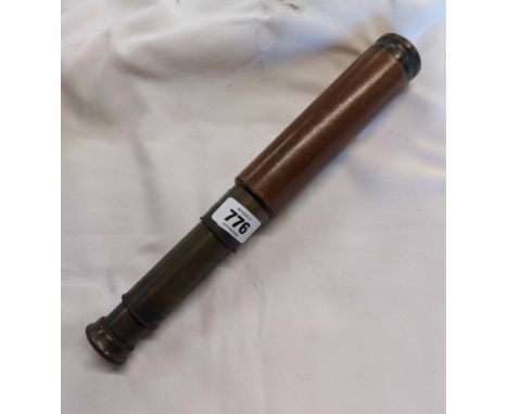 An old three draw brass telescope with stitched leather covering