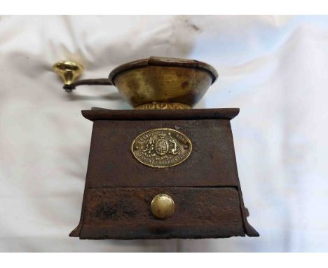 An antique Kenrick &amp; Sons cast iron and brass coffee grinder with front drawer and brass name plaque