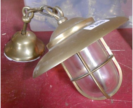 A modern hanging brass ceiling lamp of ship's style form