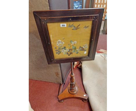 A Victorian mahogany pole screen with central embroidered panel under glass depicting birds in flight and amidst foliage, set