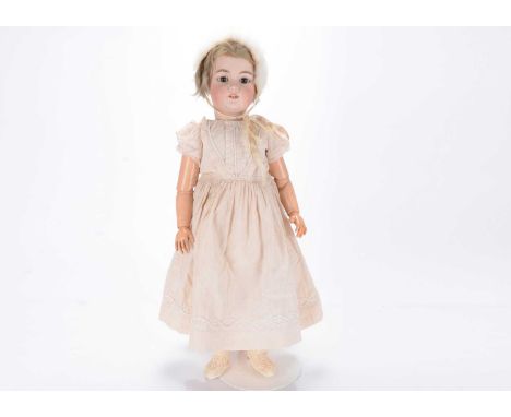 A Simon & Halbig 1079 DEP child doll,  with brown sleeping eyes, blonde mohair wig, pierced ears and a composition jointed bo