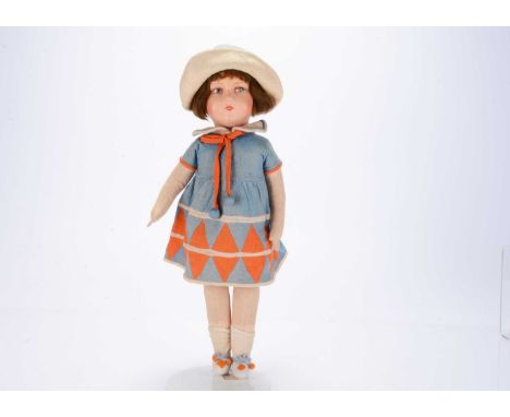 A 1930s continental composition headed doll,  with painted features, brown mohair wig, stuffed body with jointed limbs in blu