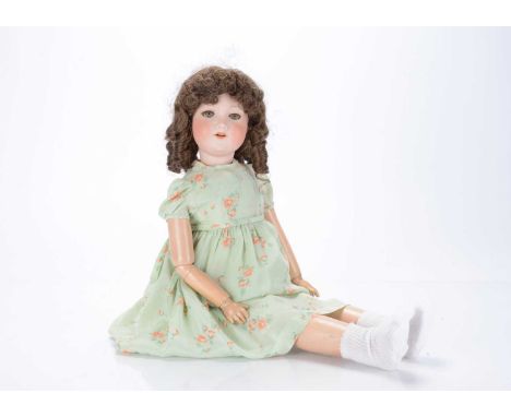 A 1920s "Nunsuch" Nunn & Smeed Bisque British Doll,  with composition body, legs are spring loaded at knees, right arm is joi