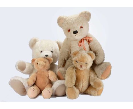 Four post-war teddy bears, a large white wool plush Twyford's bear, with orange and black plastic eyes, on brown felt backs, 