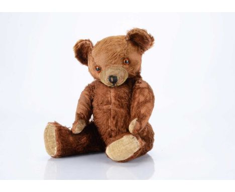 A 1930s Knickerbocker (American ) teddy bear,  with red-brown mohair, orange and black glass eyes, black stitched nose and mo