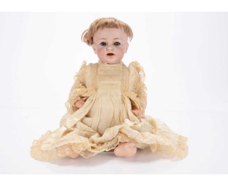 A Simon and Halbig 122 baby doll,  with blue lashed sleeping eyes, light brown mohair wig, composition bent limbs, silk and l