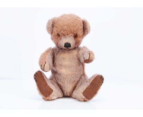 A 1930s Chad Valley Cubby bear cub, with brown and tan alpaca plush, orange and black glass eyes, black stitched nose, mouth 