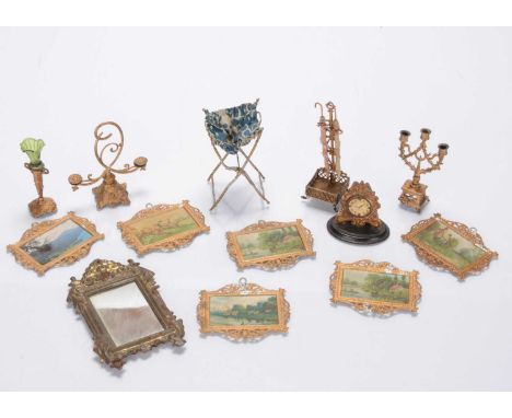 Gilt metal dolls' house chattels,  a spirit painted tinplate wall mirror —4 ¾in. (12cm.) high, six soft metal pictures, a umb