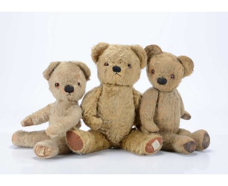 Three post-war Chad Valley teddy bears, a musical light golden mohair bear, with orange and back glass eyes, black stitched n