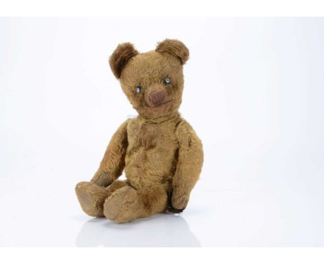 A Chad Valley 1920s Smiler teddy bear,   with golden mohair, replacement button eyes, pronounced muzzle, black stitched nose,