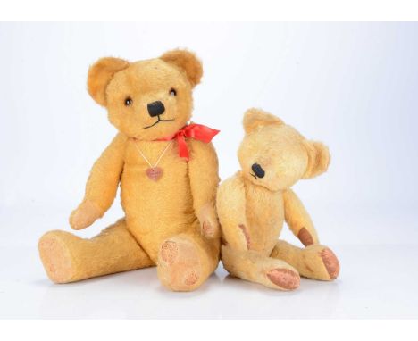 Two post-war Chad Valley teddy bears,  the larger with golden mohair, orange and black glass eyes black stitched nose and mou