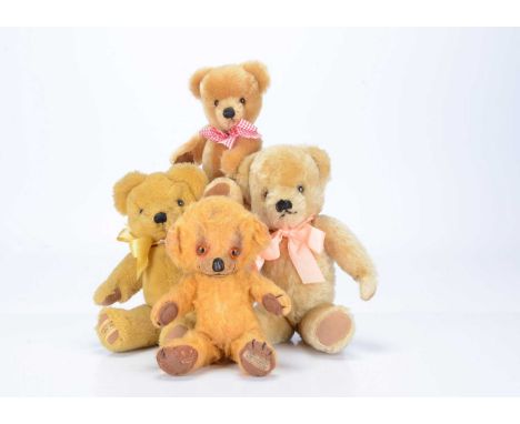 Four Merrythought teddy bears,  a golden mohair cheeky with orange and black glass eyes, black stitched nose, mouth and claws