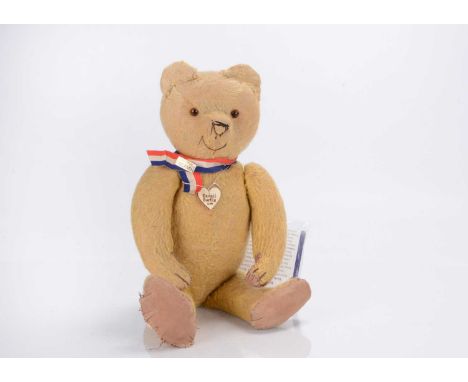 A 1920s German teddy bear,  with golden mohair, orange and black glass stick eyes, black stitched nose, mouth and claws, swiv