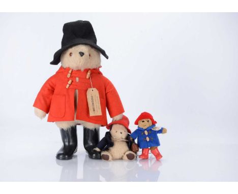 Three Paddington Bears, a Gabrielle Designs Paddington with red duffle coat, black hat, black PB wellies and label to back se