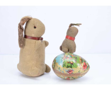 A 1930s Chad Valley standing rabbit,  with cream wool plush, orange and black glass eyes, brown velvet inner ears and red col