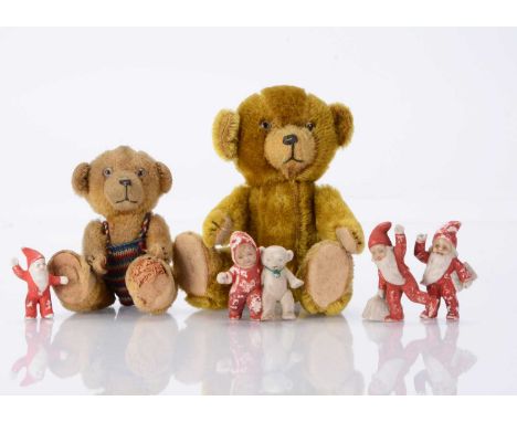 Two 1930's German bear cub teddy bears,  comprising of a larger with golden mohair, clear and black glass eyes, with remains 