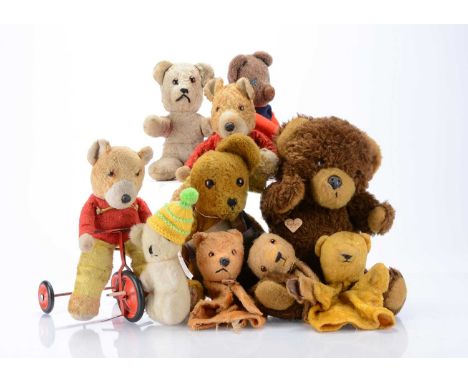 Various teddy bears and soft toys,  including a Chiltern art silk bear on a trike and another, three hand puppets, one in a S