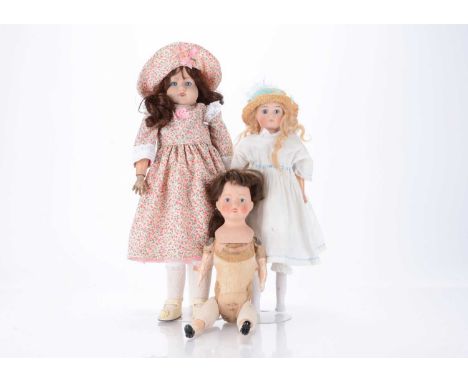 Three 1915 /20s British bisque dolls,  an interesting bisque headed doll with blue painted eyes, brown nylon wig and stuffed 