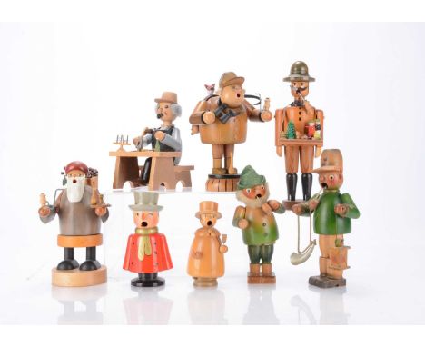 Eight recent German turned wooden Smokers, including a brush maker, a toy seller —9 ¾in. (25cm.) high, three with Erzgebirge 