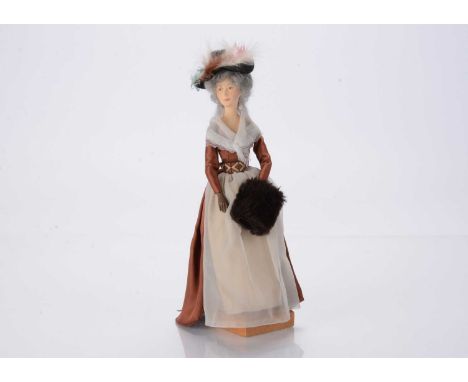 An Ann Parker artist doll modelled after a Victorian lady, cast polyester resin, with wired arms, brown dress, feather hat an