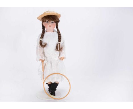An Armand Marseille 390 child doll,  with blue lashed sleeping eyes, brown nylon wig, composition jointed body, white cotton 