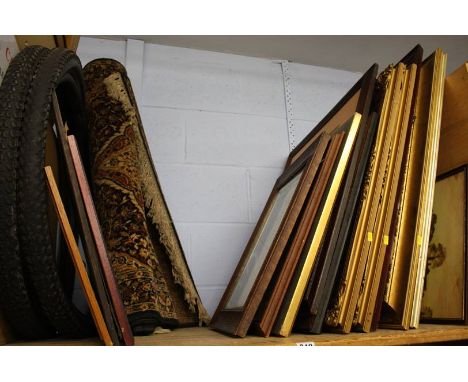 Shelf of assorted pictures, rug etc.