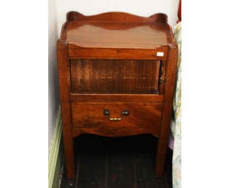 A LATE GEORGIAN MAHOGANY NIGHT-TIME BEDSIDE COMMODE,  with saw cut gallery top, incorporating two handles, above a tambour co