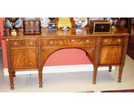 A WILLIAM IV PERIOD MAHOGANY SIDEBOARD,  probably Irish, with three quarter back and plate rack above gadroon edge, and three