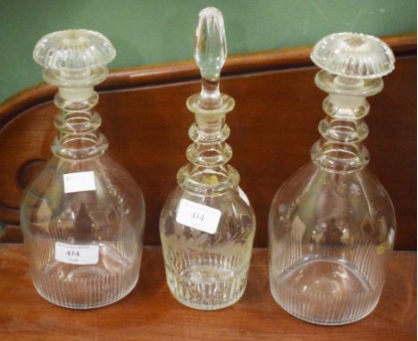 TWO SIMILAR GLASS DECANTERS,  probably Irish, each with triple neck rings and mushroom stopper and a flute cut band to base, 