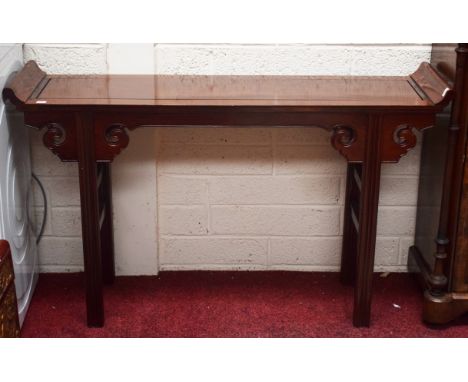 A CHINESE CHERRYWOOD ALTER TABLE, with curved up sides, raised on square moulded legs headed with scroll cut spandrels, 30" (