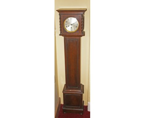 A SMALL INLAID OAK CHIMING GRANDMOTHER CLOCK,  with circular dial, and Arabic numerals, the paneled trunk with door, raised o