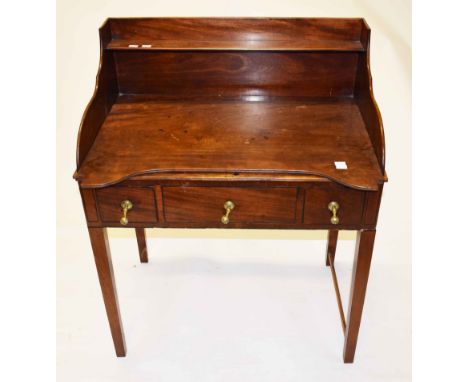 A GEORGE IV PERIOD MAHOGANY WASHSTAND,  the three quarter gallery with a shelf, the top with an open basin aperture and a fri