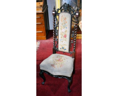 A VICTORIAN ROSEWOOD PRIE DIEU,  the high back with a tapestry panel, above a serpentine shaped seat, and raised on front cab