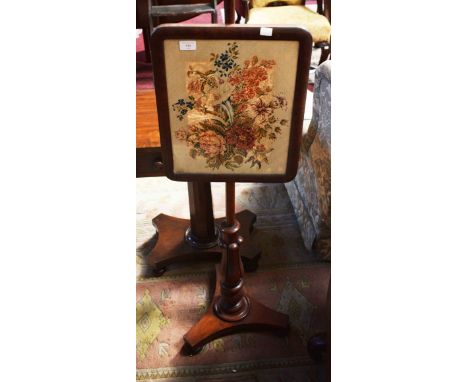 A VICTORIAN POLE SCREEN, with floral tapestry panel, on baluster reeded stem and triform base, with bun feet, 58in (148cm). (