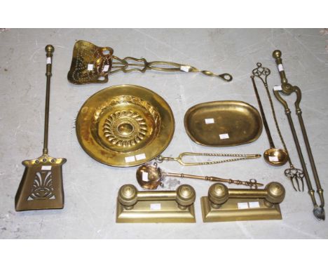 A PAIR OF BRASS FIRE DOGS,  a brass chestnut roaster; two brass ladles; a toasting fork; a small tongs; a fire shovel and ton