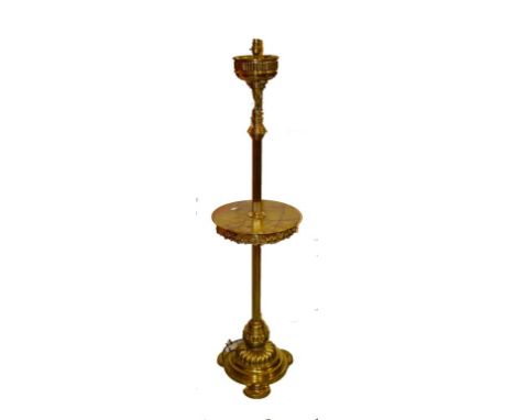 A LATE 19TH OR EARLY 20TH CENTURY BRASS STANDARD OIL LAMP, now converted for electricity, the reeded column with a centre cir