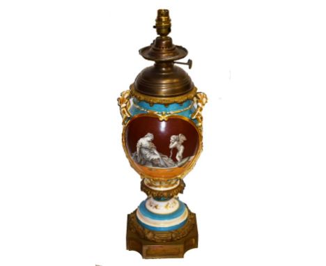 A FRENCH PORCELAIN AND BRASS-MOUNTED OIL LAMP,  converted for electricity, the baluster vase shaped body profusely decorated 