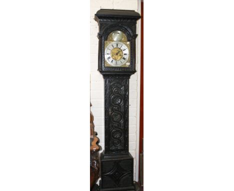 AN EIGHT-DAY CARVED OAK LONG CASE CLOCK,  with rectangular domed pediment, above an arched brass dial by John Evans Shrewsbur