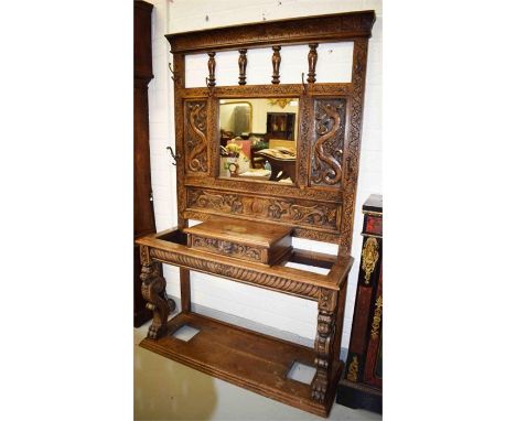 A VERY ATTRACTIVE CARVED OAK HALL STAND, early 20th century, in the 17th century style, the back with a rectangular mirror pa