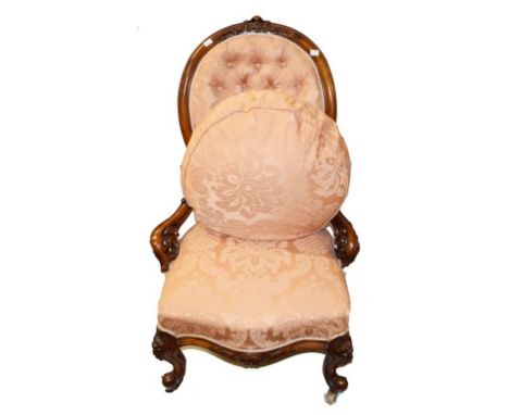 AN ATTRACTIVE VICTORIAN WALNUT OCCASIONAL CHAIR,  the oval moulded back, with a padded panel and a serpentine fronted seat, o