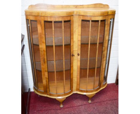 AN ART NOUVEAU STYLE WALNUT DOUBLE BOW FRONTED DISPLAY CABINET, on cabriole legs, 44" (112cm)w. (1) 