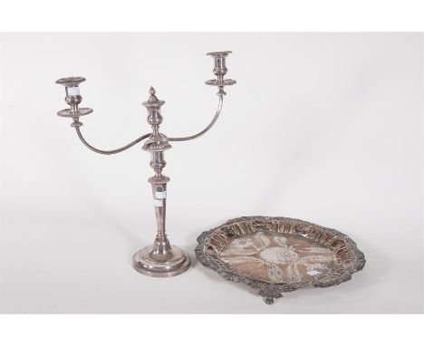 A TWO-BRANCH THREE-LIGHT SILVER PLATED CANDELABRUM, 17in (43cm); together with a circular silver plated salver, on three legs