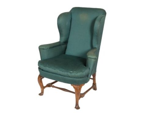A LATE 18TH CENTURY WALNUT WING ARMCHAIR, with loose cushion, covered in green fabric, raised on front cabriole legs with pad