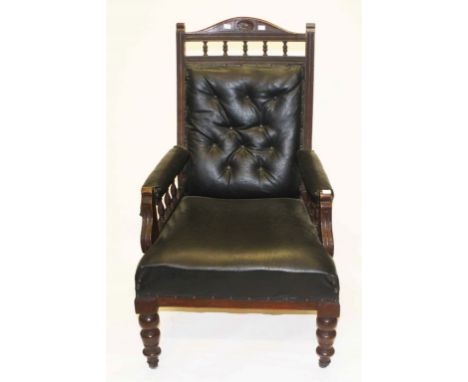 AN EDWARDIAN WALNUT ARM CHAIR,  with button back, on front turned legs. (1)