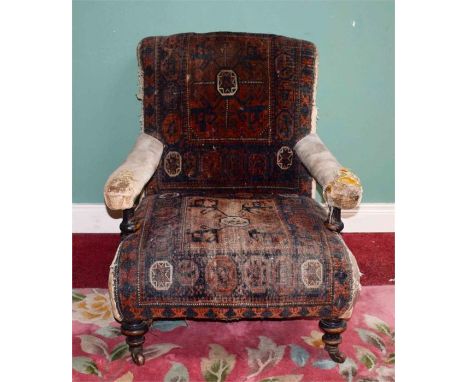 A VICTORIAN WALNUT OPEN EASY ARMCHAIR, covered in tapestry type fabric and raised on front turned legs. (1) 